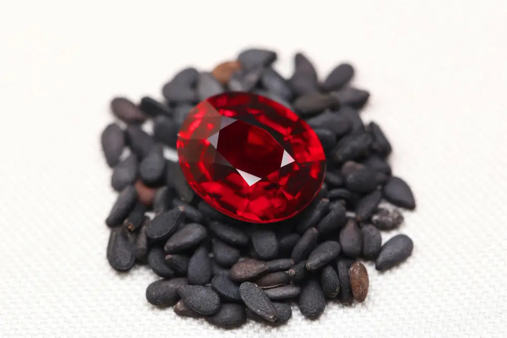 Polished Pyrope garnet gemstone with fiery red hues.